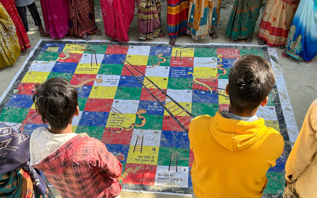 Youth playing snakes and ladders board game